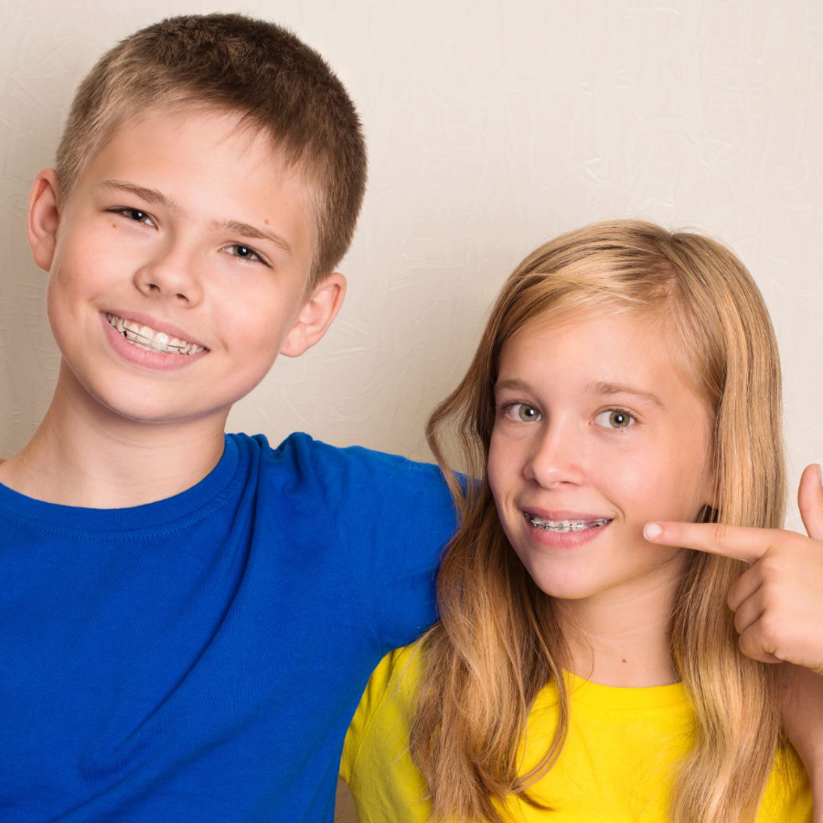 adult woman and child smiling with braces